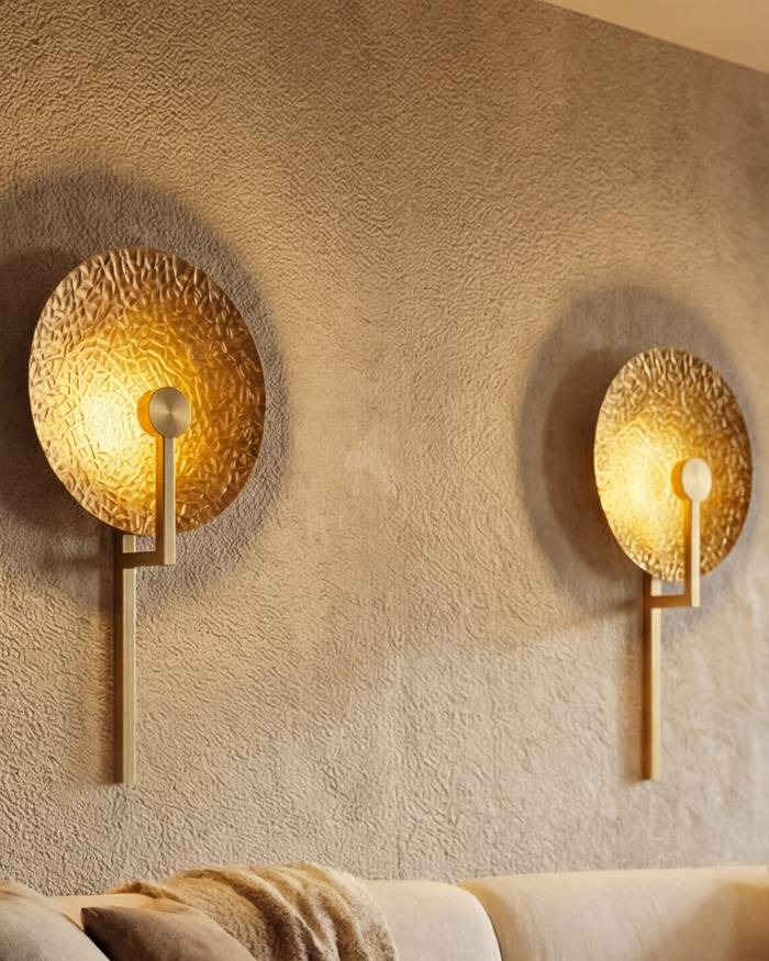 Aaranya Halo Wall Light Handcrafted Solid Brass Designer Wall Sconce | Made in India Two gold wall sconces on a textured wall with a soft glow.