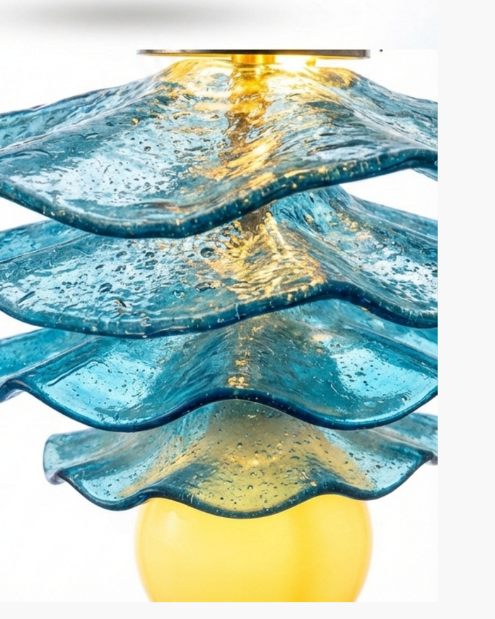 Decorative lamp with wavy blue glass design on a white background