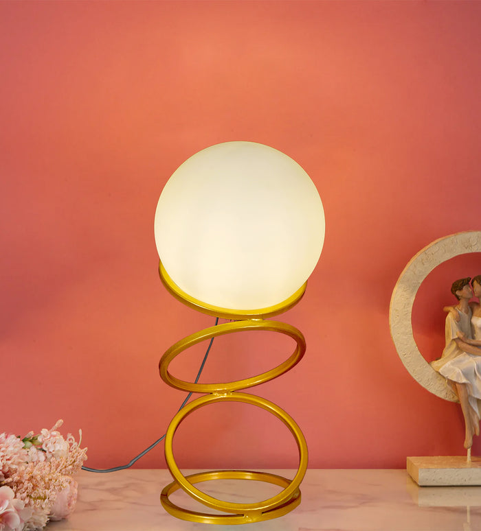 Enhance your space with the Luna Glow Modern Milky Glass LED Table Lamp. This sleek, gold spiral base with a soft-glowing glass globe adds elegance to any room. Shop now for cozy, energy-efficient lighting - Aartaa decor
