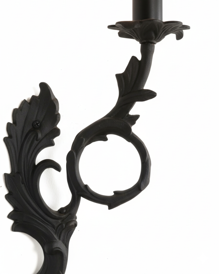 Decorative black metal candle holder on a white background